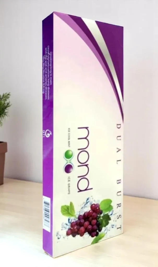 Mond Dual Burst บุหรี่เย็นสองเม็ดบีบ: แพ็กเกจสีน้ำเงินเขียวสะท้อนความเย็นสดชื่น เห็นโลโก้ Mond ชัดเจน