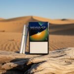 ซองบุหรี่ Mevius Option Fizzy Dew No.5 และมวนบุหรี่ วางบนขอนไม้กลางทะเลทราย แสงแดดสีทอง กลิ่นเมล่อนเมนทอล